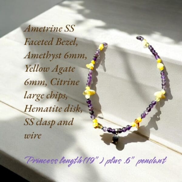 A necklace with purple and yellow beads on it.