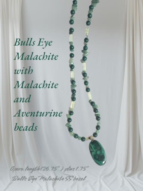 A necklace with beads and an oval shaped stone.