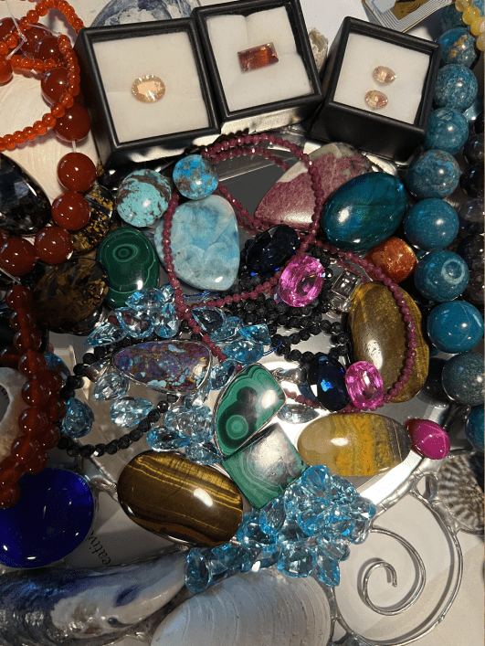 A bunch of different colored beads and stones