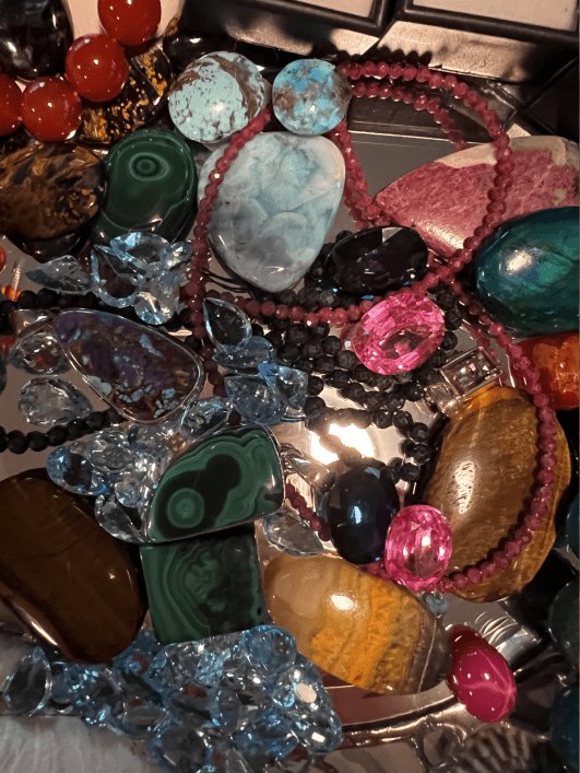 A pile of different colored stones and beads.