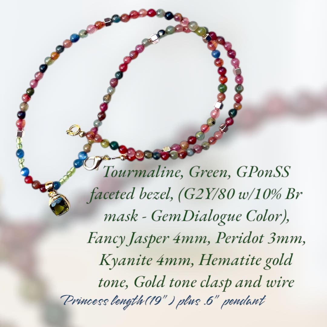 A necklace with colorful beads and a small red bead.