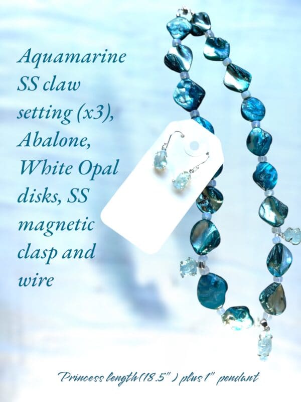 A necklace with blue beads and a white opal disk.