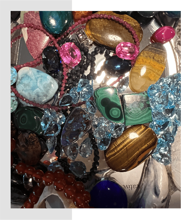 A bunch of different colored stones and beads