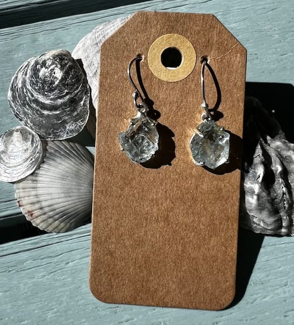 A pair of earrings sitting on top of a card.