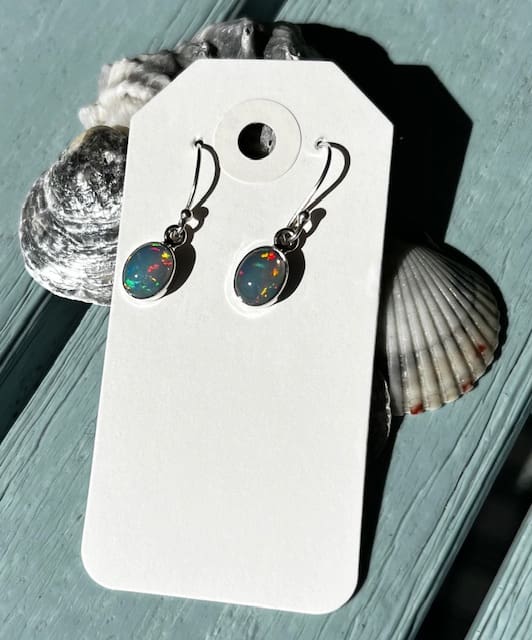 A pair of earrings sitting on top of a card.