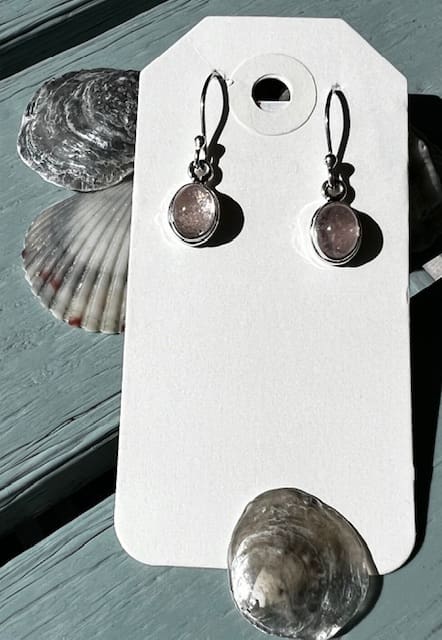 A pair of earrings hanging on the wall.