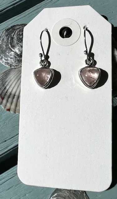 A pair of earrings hanging on a card.