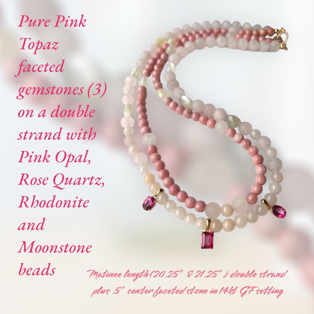 A pink and white necklace with a pink stone.