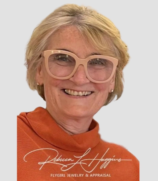 A woman with glasses and blonde hair wearing an orange shirt.