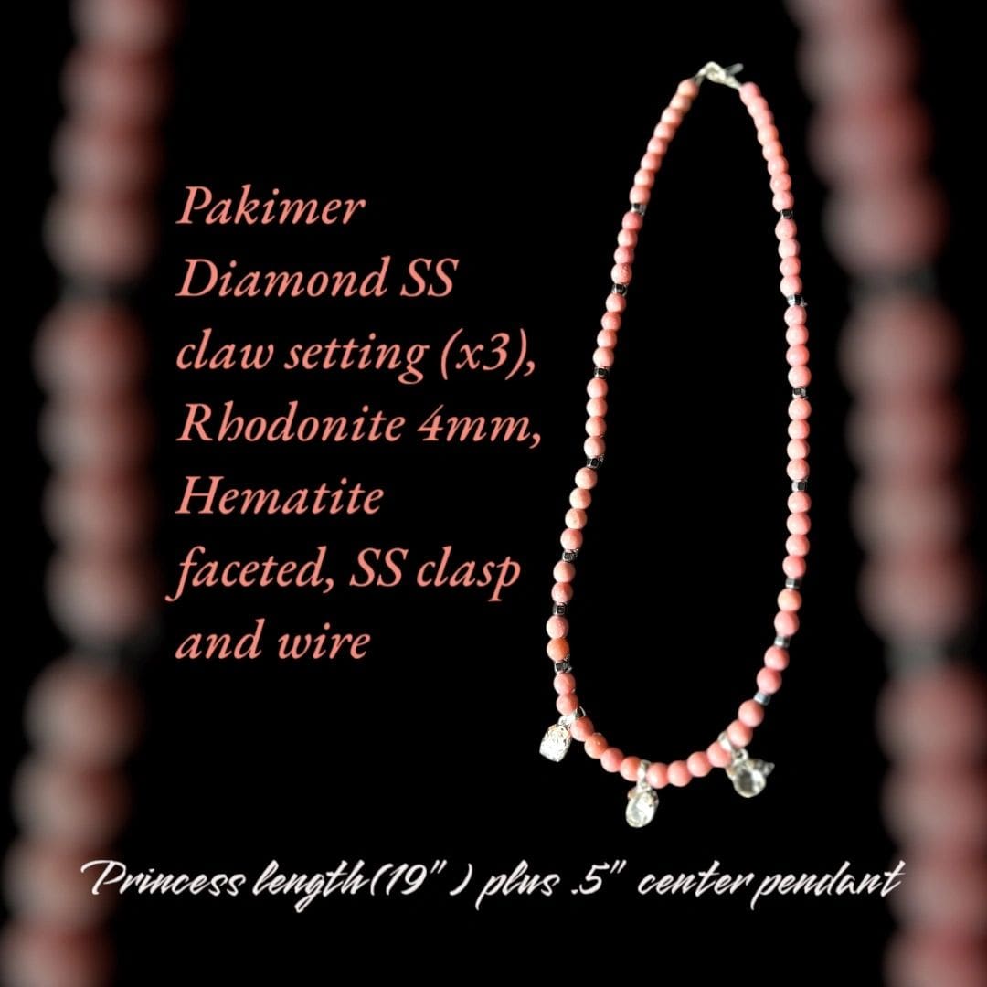 A necklace with pink beads and silver charms.