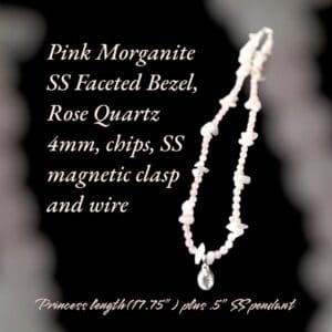 A necklace with a small white bead and a large pink bead.