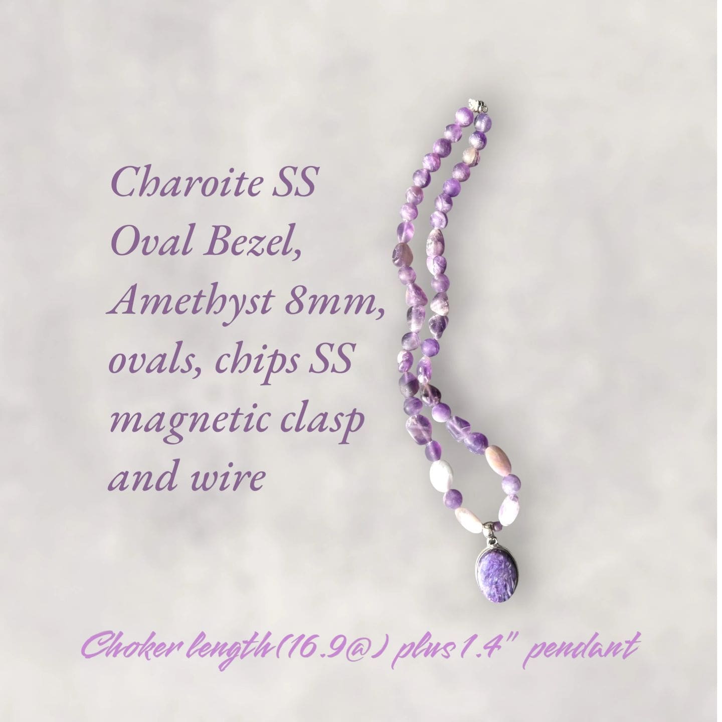 A purple necklace with an oval bead and a purple charm.