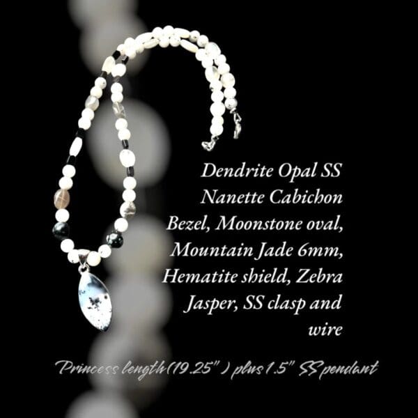 A necklace with a pearl and an inscription on it.