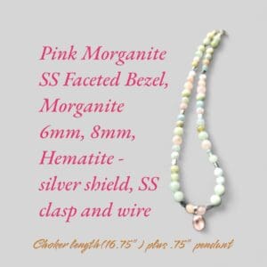 A necklace with pink and green beads on it.