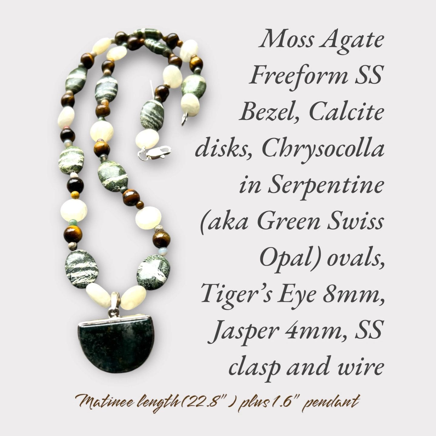 A necklace with a black and white bead, a green stone, and a tiger 's eye bead.