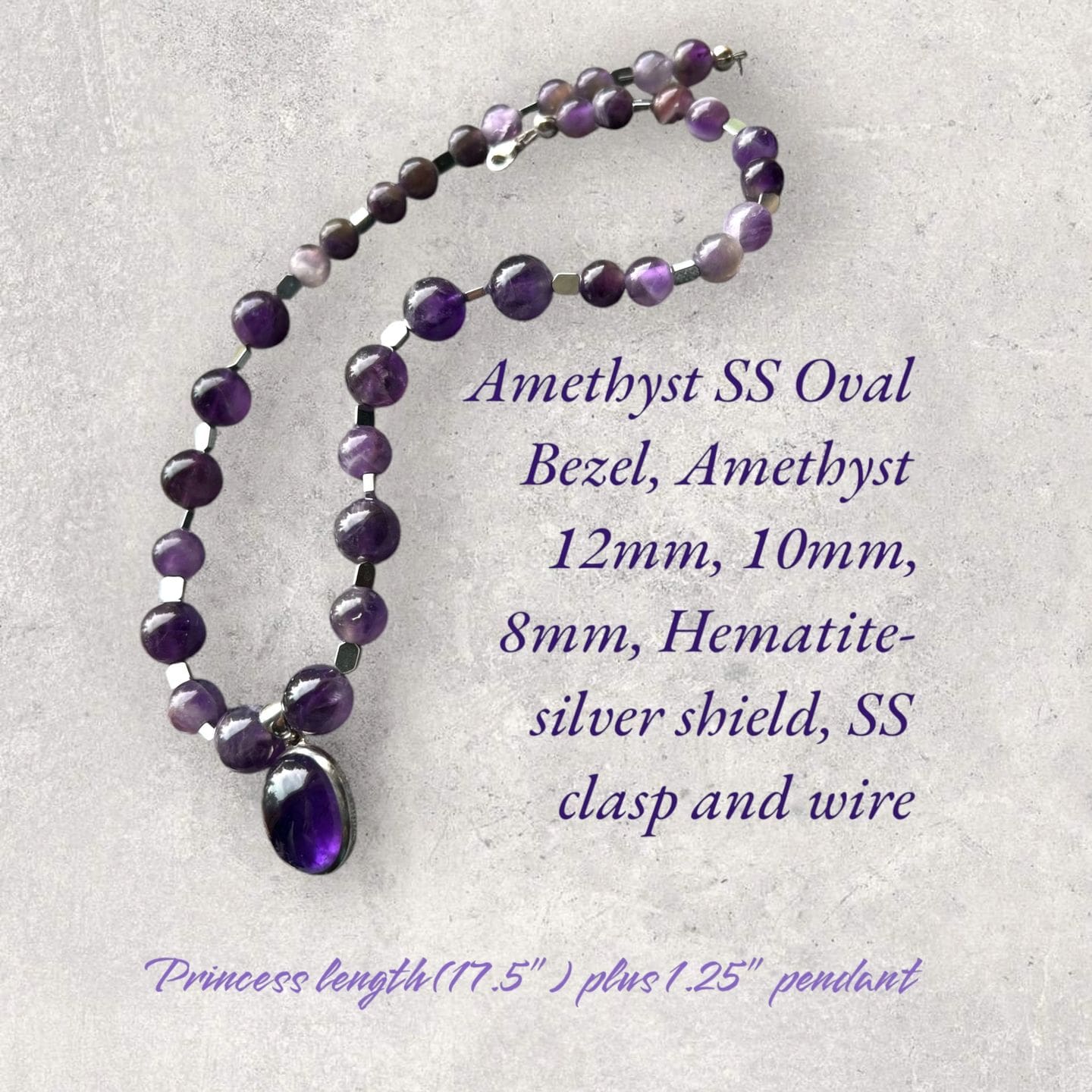 A necklace with amethyst beads and a silver bead.