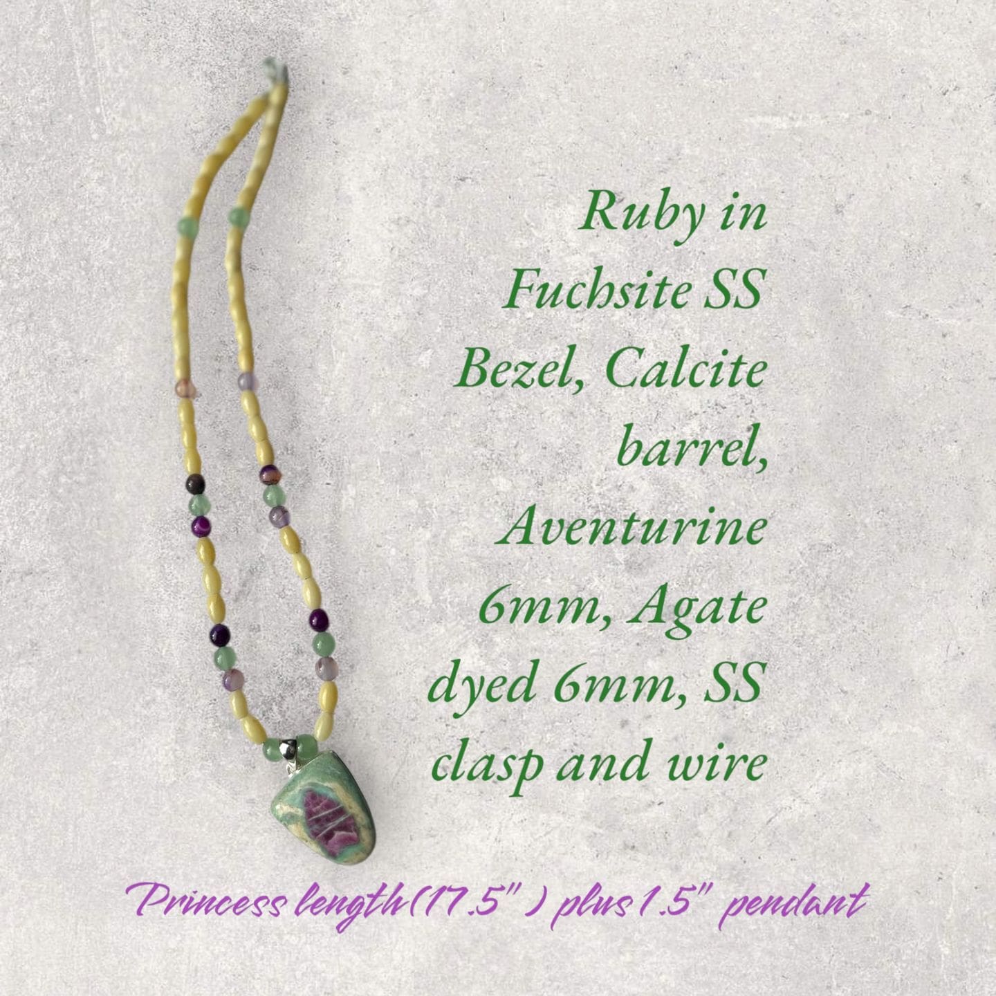 A necklace with a green bead and a yellow bead.