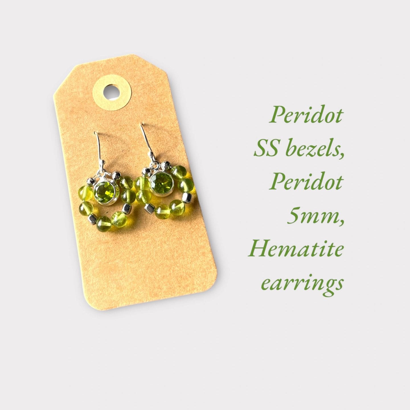 A pair of earrings sitting on top of a card.