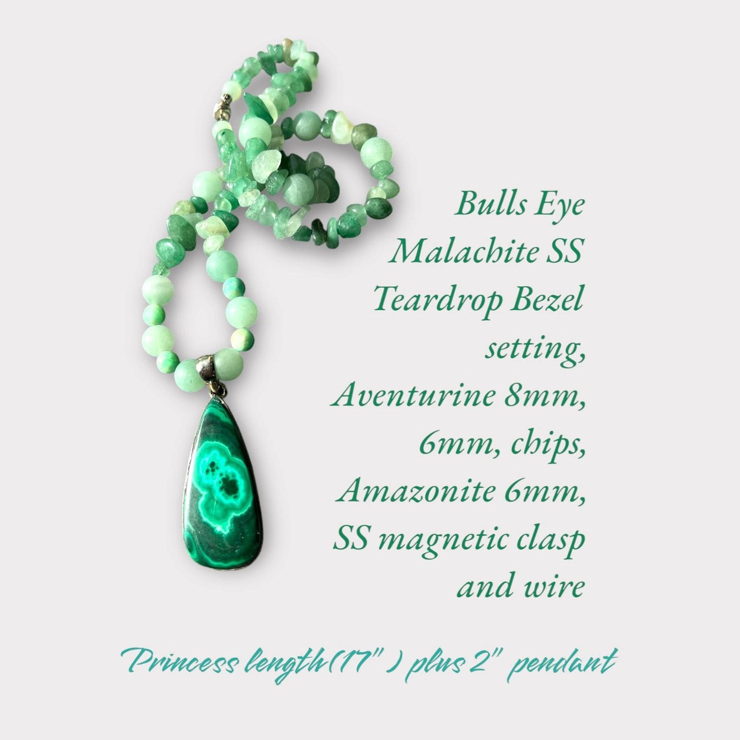 A green bead necklace with an oval shaped stone.